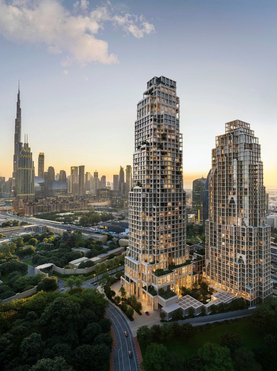 Two residential towers at sunset with the Burj Khalifa skyline in the distance