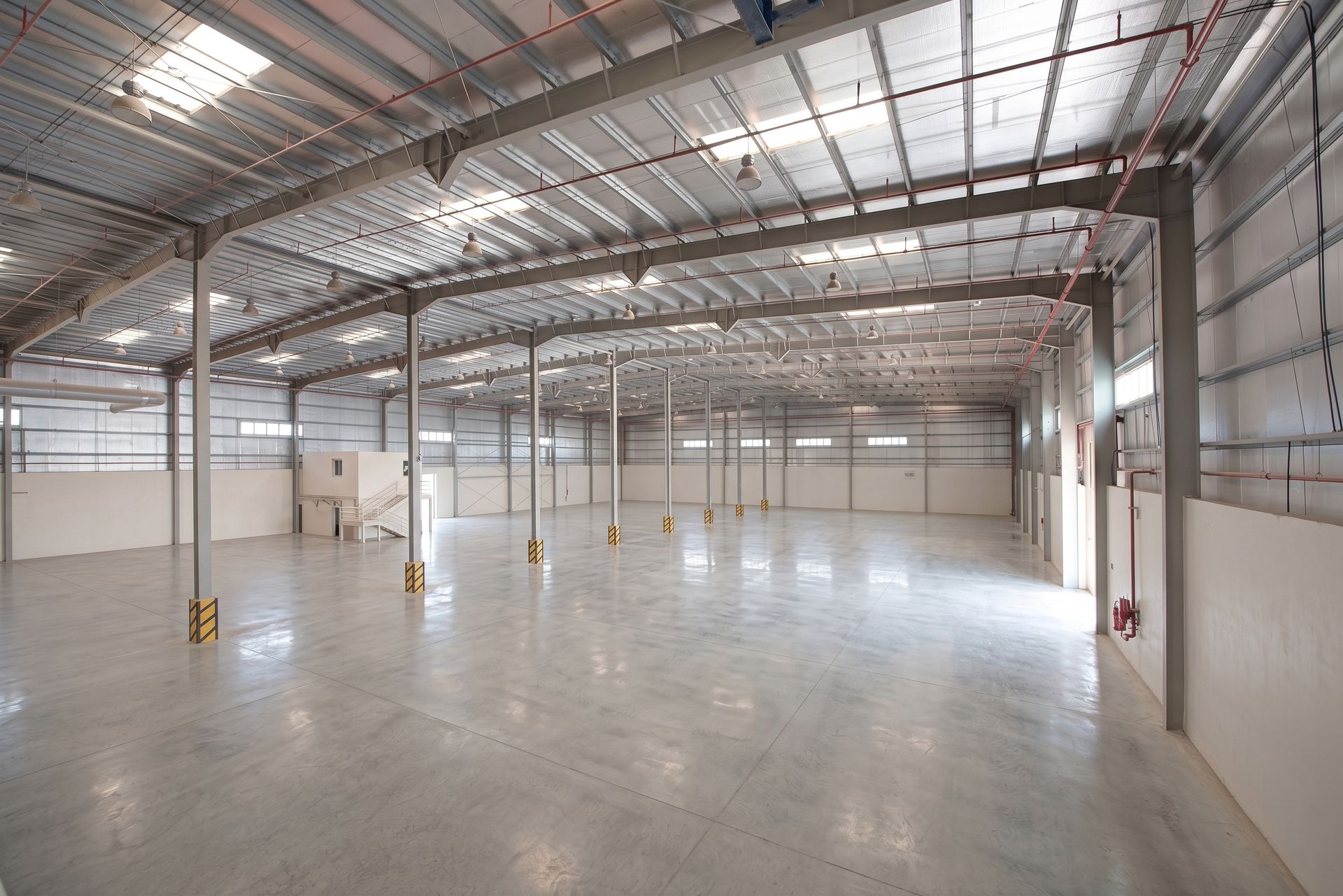 Spacious warehouse interior with a high steel roof